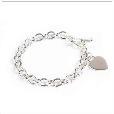 Girls sterling wide link charm bracelet with engraved heart.